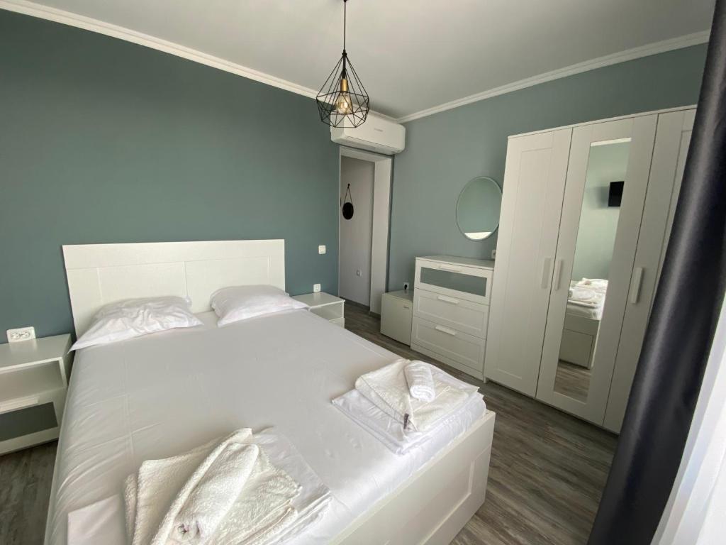 a bedroom with a white bed and a mirror at Your Room Primorsko in Primorsko