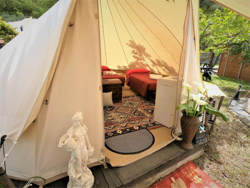 a tent with a living room in it at Gole Alcantara mini Glamping Lanternavacanze in Motta Camastra