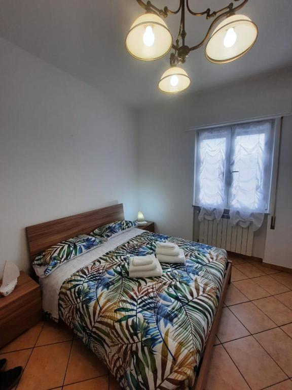 a bedroom with a bed with two towels on it at CASA PRIMAVERA in Vado Ligure