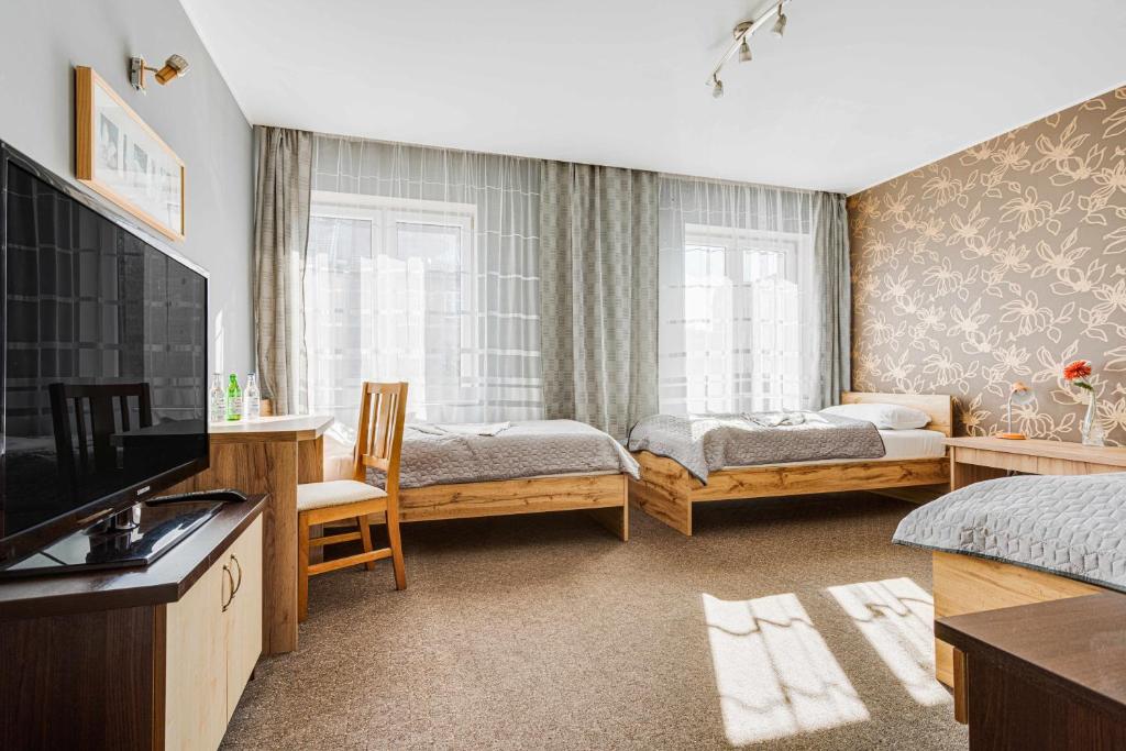Posteľ alebo postele v izbe v ubytovaní Hotel Sowa