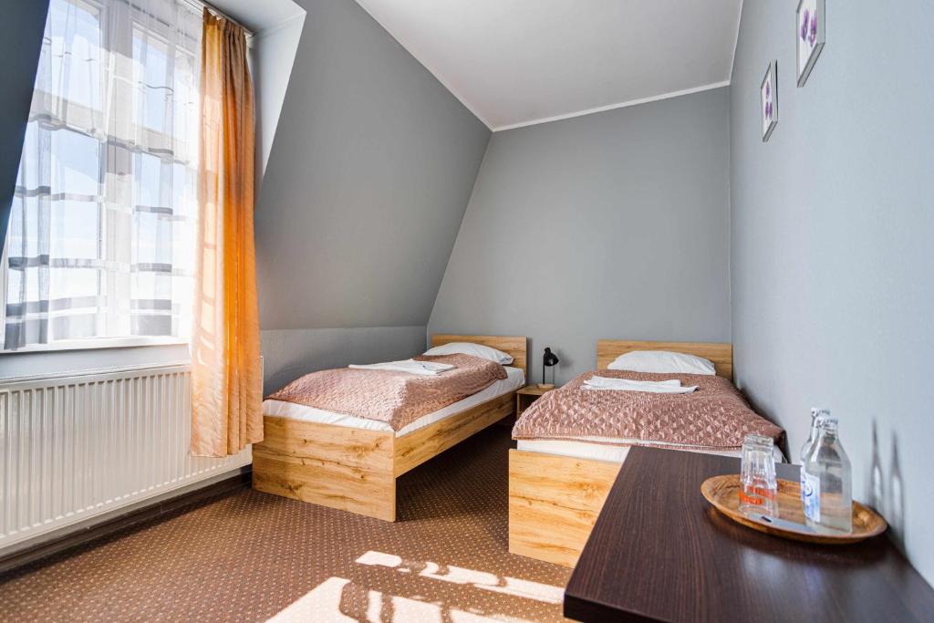 Posteľ alebo postele v izbe v ubytovaní Hotel Sowa