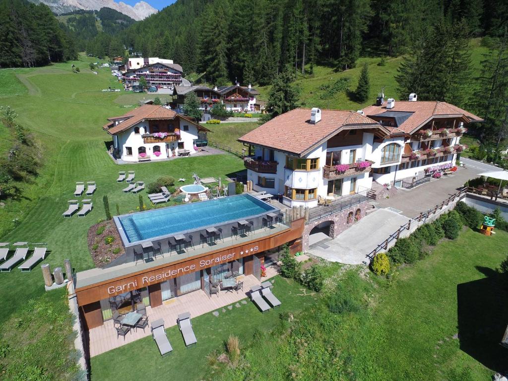 an aerial view of a building with a swimming pool at Garni Residence Soraiser in Selva di Val Gardena