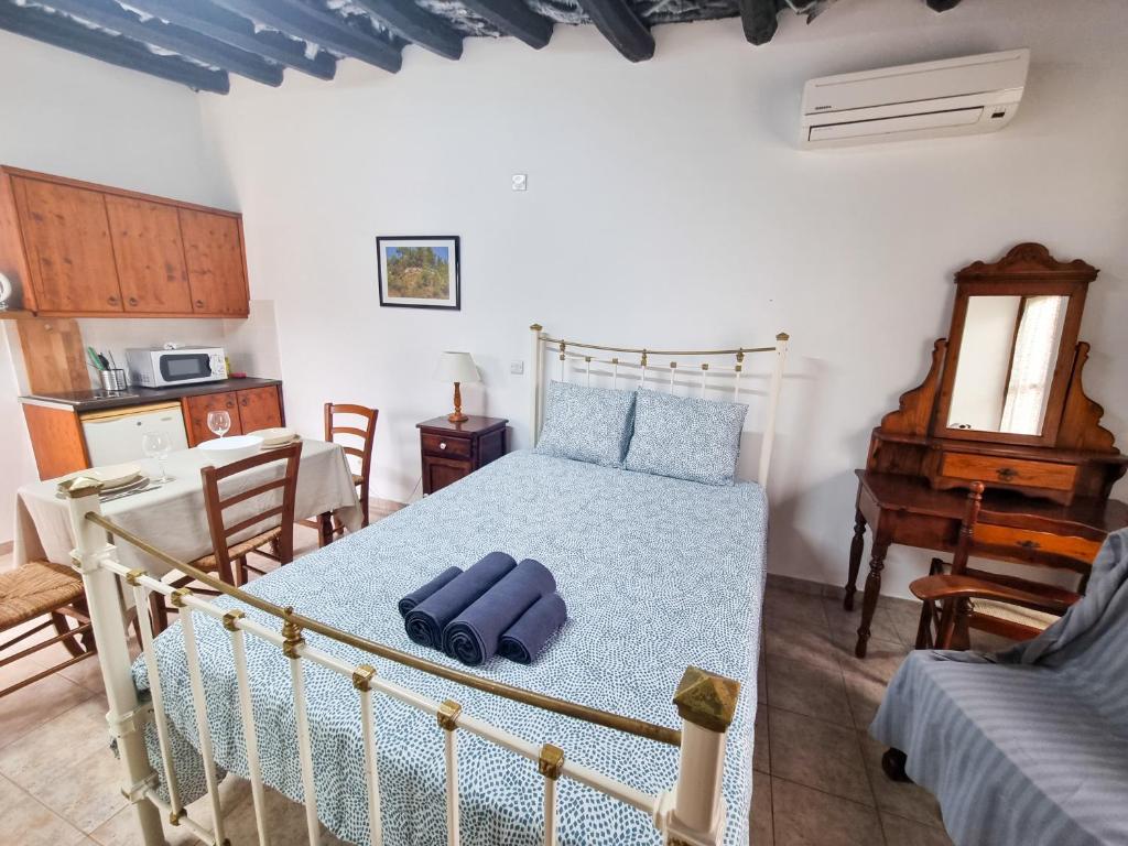 a bedroom with a bed and a table and a piano at Poseidon's Pool Paradise in Skarinou