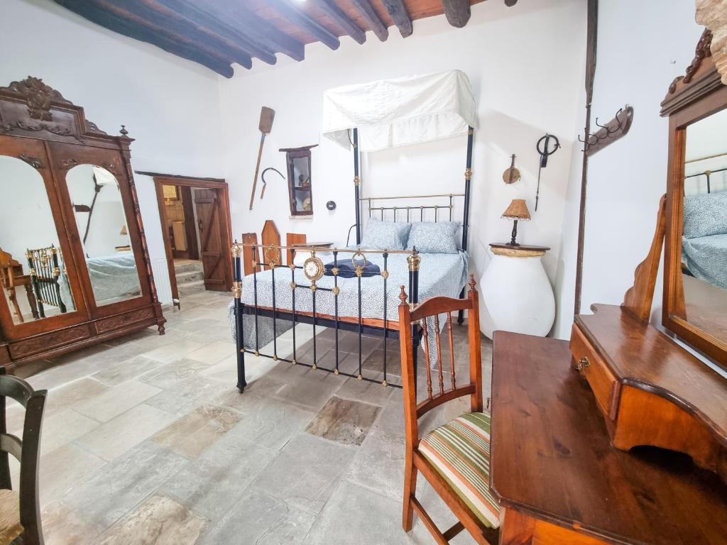 a bedroom with a bed and a dresser and a mirror at Poseidon's Pool Paradise in Skarinou