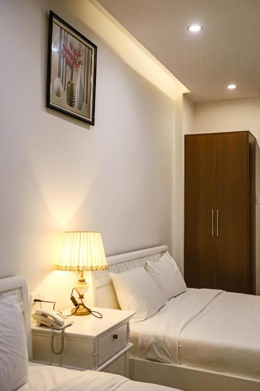 Giường trong phòng chung tại SeaColor Beachstay Danang Hotel by Haviland
