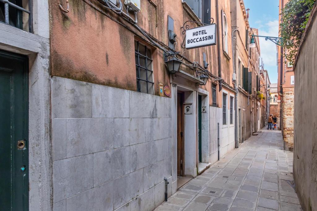 an alley with a sign that reads first pharmacy at Hotel Casa Boccassini in Venice