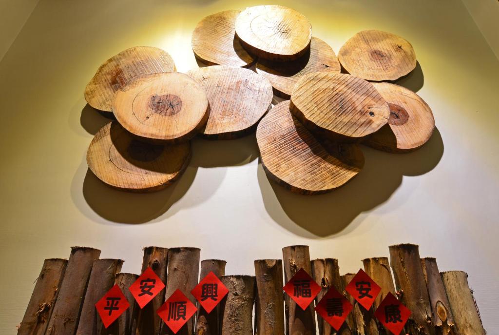 a bunch of wooden mushrooms hanging on a wall at Yunju House in Jiaoxi