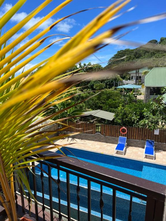 a view of the pool from the balcony of a resort at The Runway Lodge in Pointe Larue