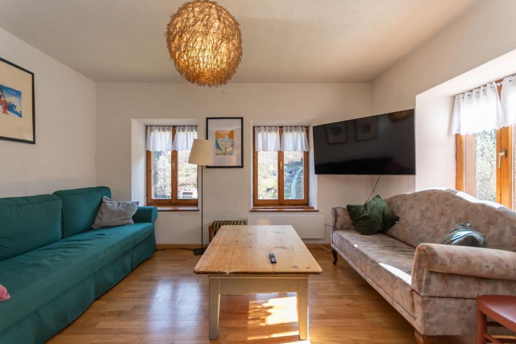 a living room with a couch and a table at Casa Narciso in Rocca Pietore