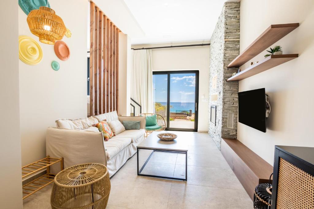 a living room with a couch and a table at Euphoria Suites in Karpathos Town