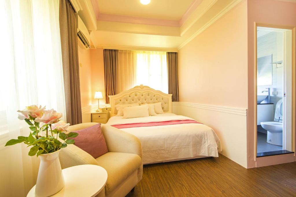 a hotel room with a bed and a couch at Yunju House in Jiaoxi