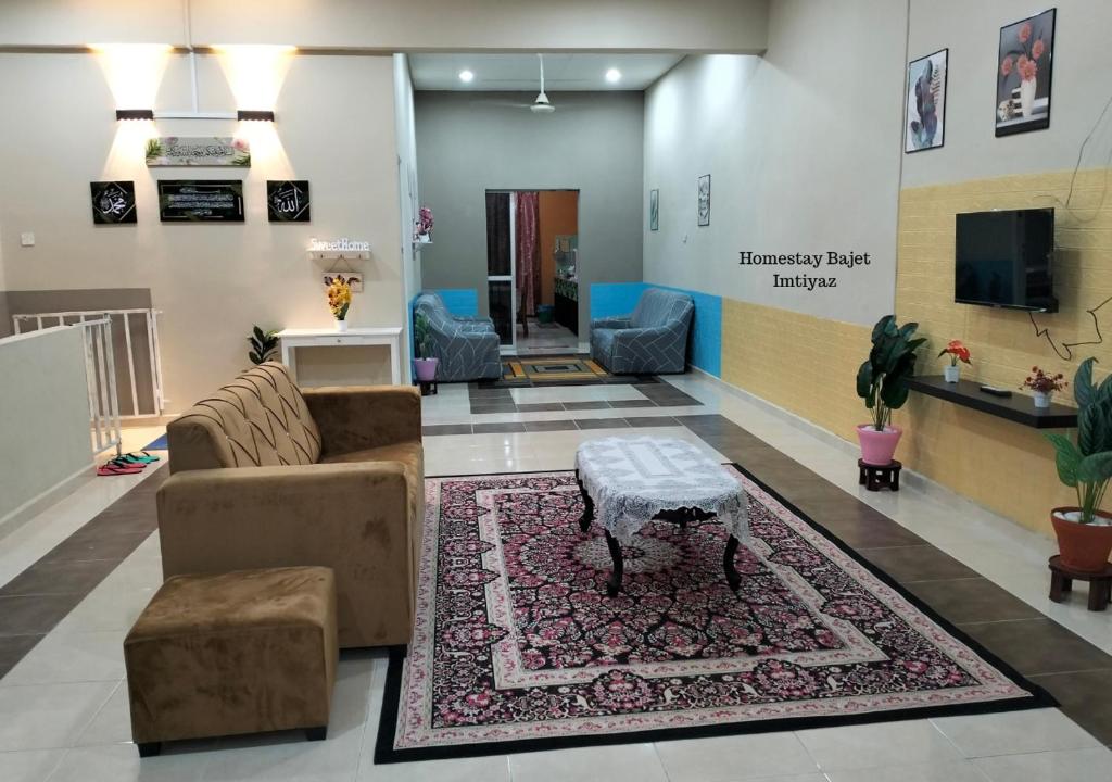 uma sala de estar com um sofá e uma mesa em Homestay Bajet Imtiyaz, Terengganu em Bukit Payong