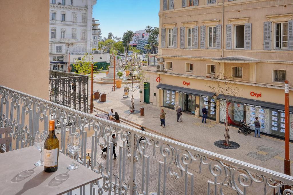a bottle of wine sitting on a table on a balcony at MODERNE 3 PIECES IDEALEMENT SITUE CENTRE DE CANNES l! A2B22 in Cannes