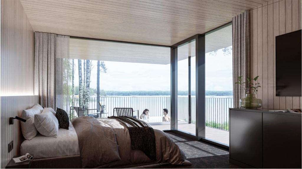 a bedroom with a bed and a large glass window at Sahanlahti Resort in Puumala