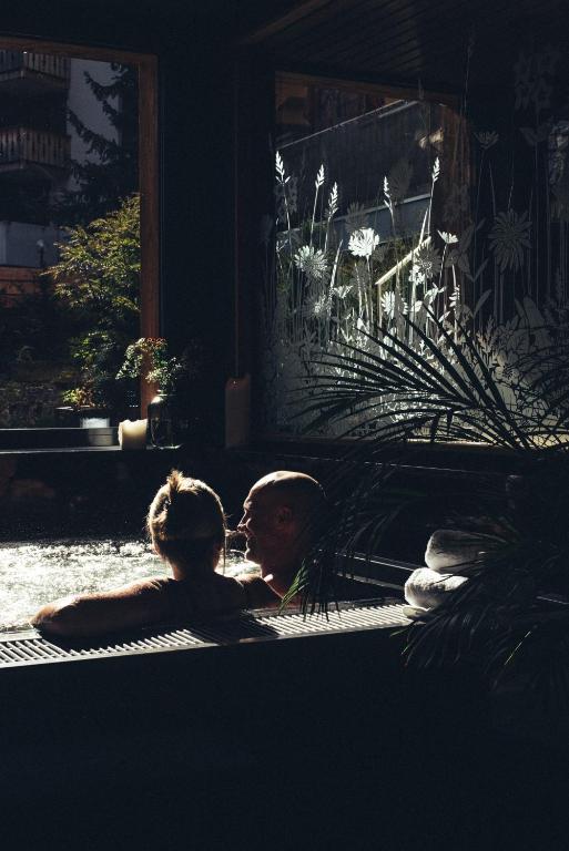 a man and a woman laying on the floor at Hôtel de Verbier SUP in Verbier