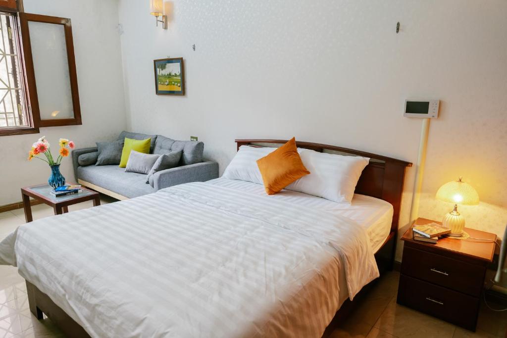 Postel nebo postele na pokoji v ubytování Hola House Hanoi