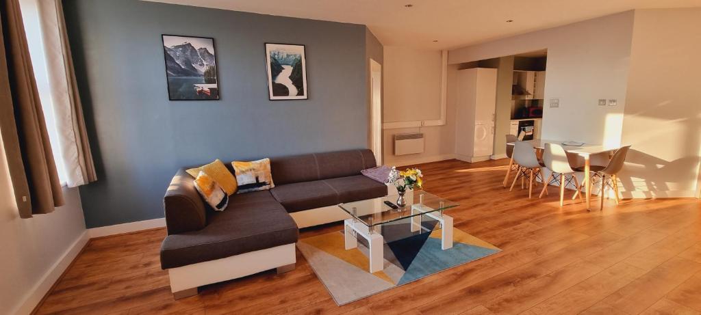 a living room with a couch and a table at Modern and spacious Swansea centre apartment in Swansea