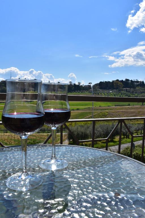 two glasses of red wine sitting on a table at Casa Iole in Montepulciano