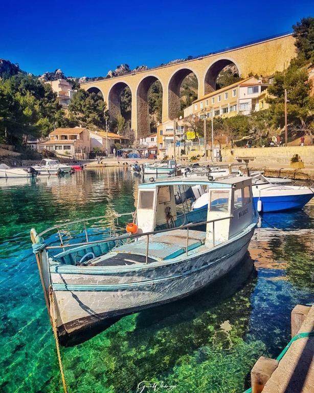 a boat is docked in the water near a bridge at La Belle Vue in Sausset-les-Pins