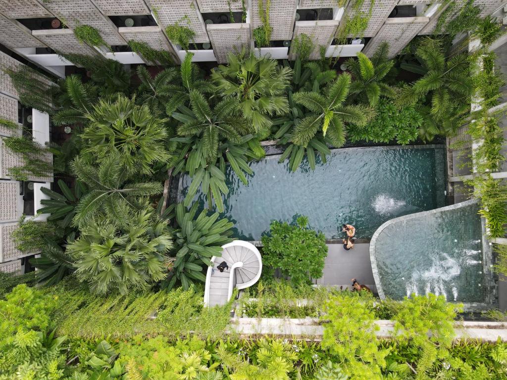 an overhead view of a swimming pool with plants at Baitong Hotel & Resort Phnom Penh in Phnom Penh