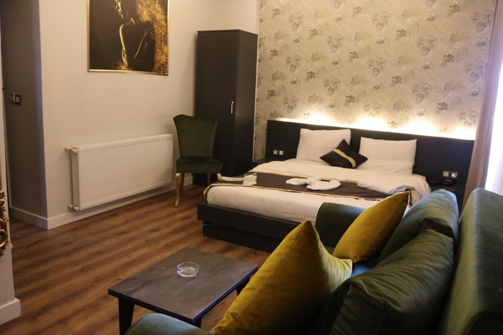 a hotel room with a bed and a couch at Ortek Hotel Taksim in Istanbul