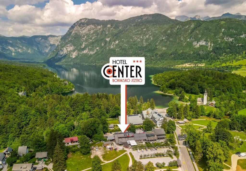 an aerial view of a hotel center sign and a lake at Hotel Center Bohinjsko Jezero in Bohinj