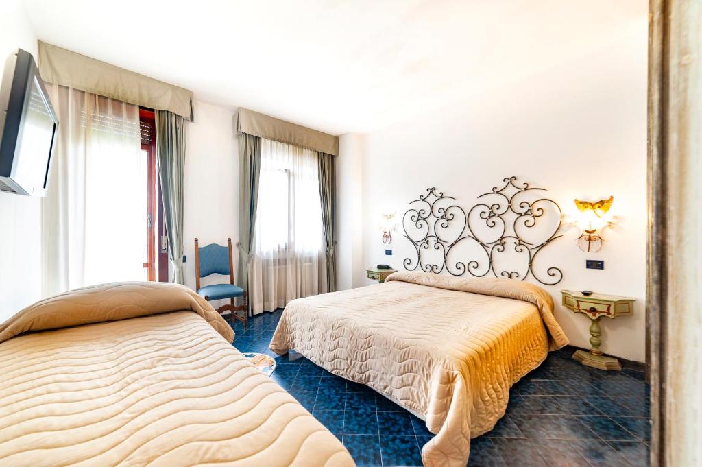 Postel nebo postele na pokoji v ubytování Hotel Terme Don Pepe