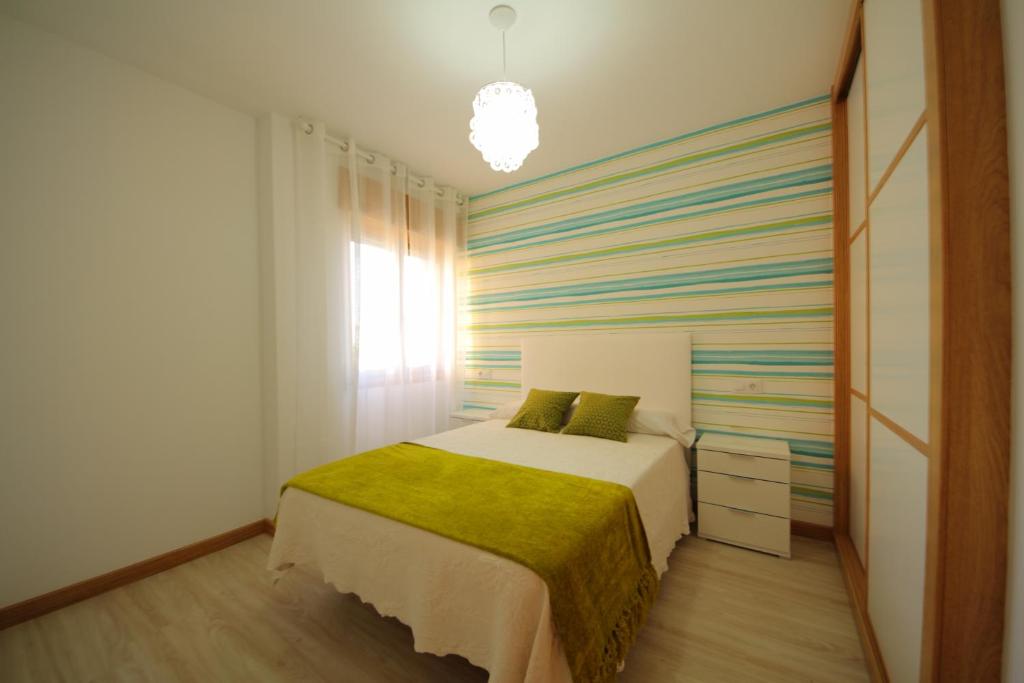 A bed or beds in a room at Apartamentos Montalvo Leiro
