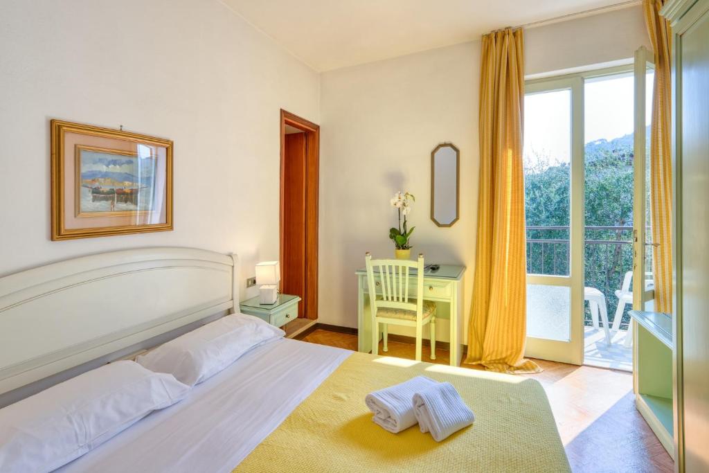 Postel nebo postele na pokoji v ubytování Hotel Silvana Garnì