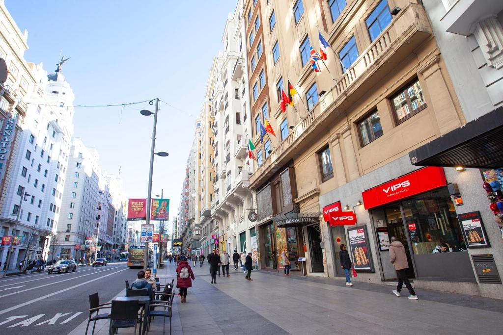a busy city street with people walking on the sidewalk at Espahotel Gran Vía in Madrid