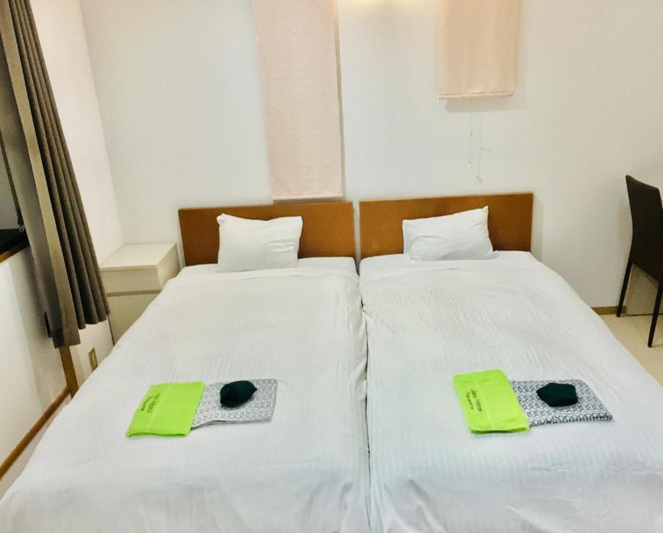 Postel nebo postele na pokoji v ubytování JAS HOTEL TAKAYAMA