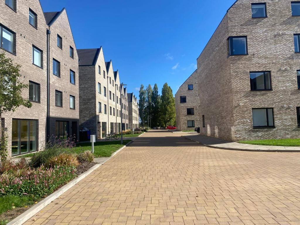 a cobblestone street between two brick buildings at For Students Only Ensuite Bedrooms at Westwood Student Mews in Warwick in Coventry