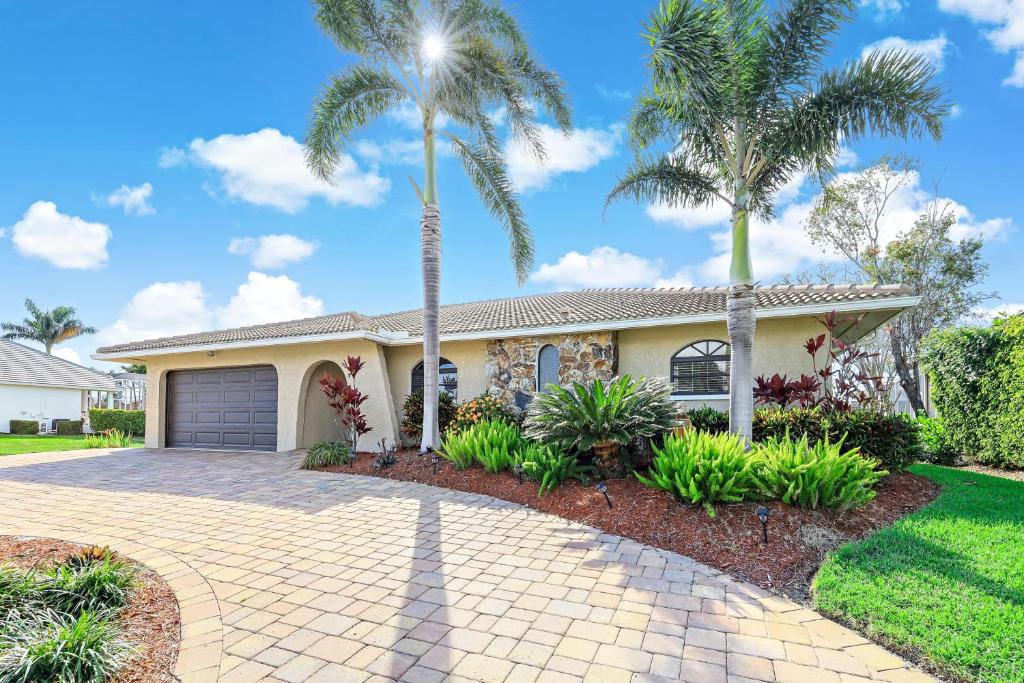 a house with palm trees in front of it at 152 Leeward Court in Marco Island