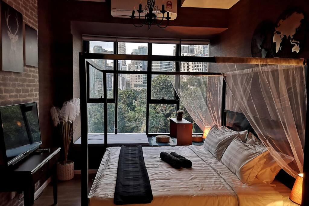 a bedroom with a bed and a large window at Romantic Log Cabin 2 - Heart of KL, near KLCC/KL Tower in Kuala Lumpur