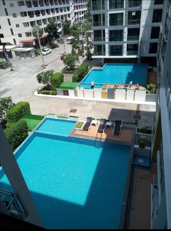 an overhead view of two swimming pools in a building at Neo2 condo 703 in Jomtien Beach