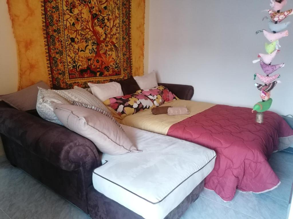 a bedroom with a bed and a couch at Demetra Piccola Casa Vacanze in Ielsi