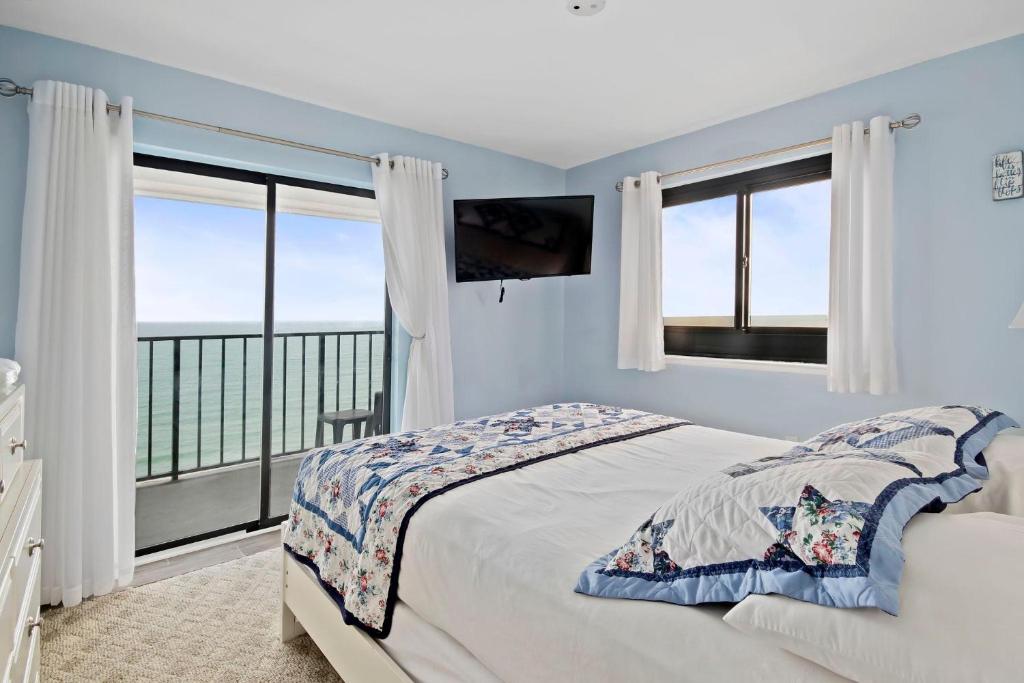 a bedroom with a bed and a large window at Myrtle Beach Resort T1402 in Myrtle Beach