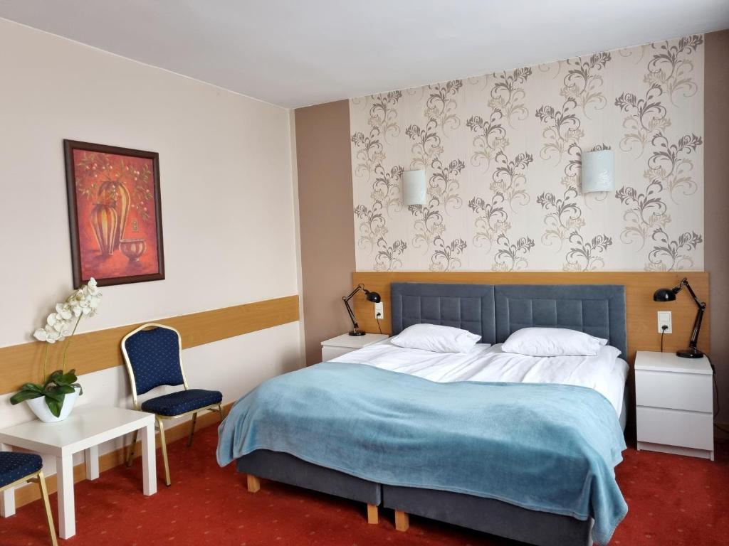 Postel nebo postele na pokoji v ubytování Hotel Orbita
