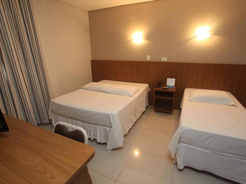 Postel nebo postele na pokoji v ubytování Hotel Plaza Cascavel