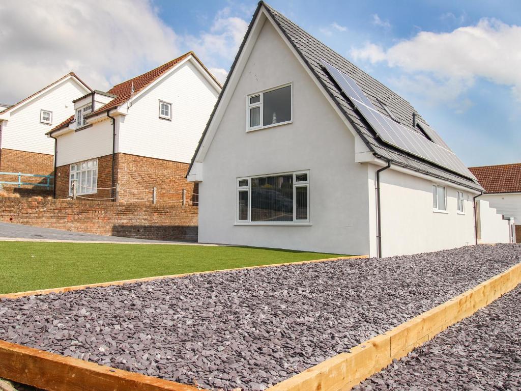 a house with a gravel driveway at The White House in Weymouth