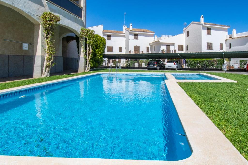 a swimming pool in the yard of a house at Rentalmar Nabila in Miami Platja