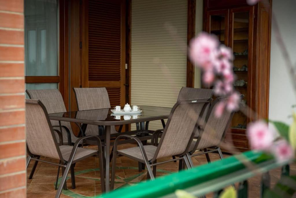 a table and four chairs on a porch with a table and chairs at [Sea Garden] Elegant Villa with a View in Rio nellʼElba