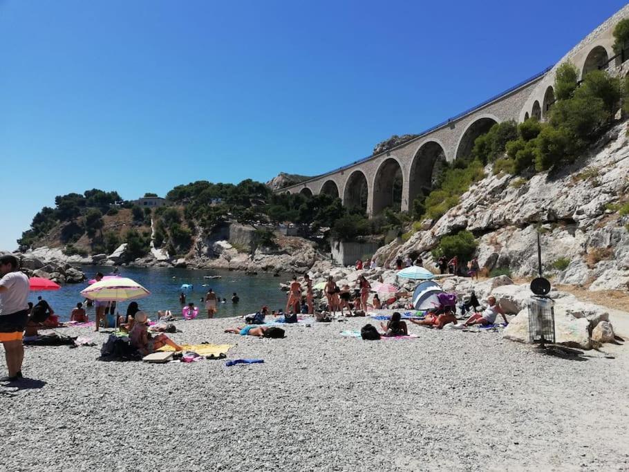 a group of people on a beach near a bridge at Appartement 1er arrondissement in Marseille