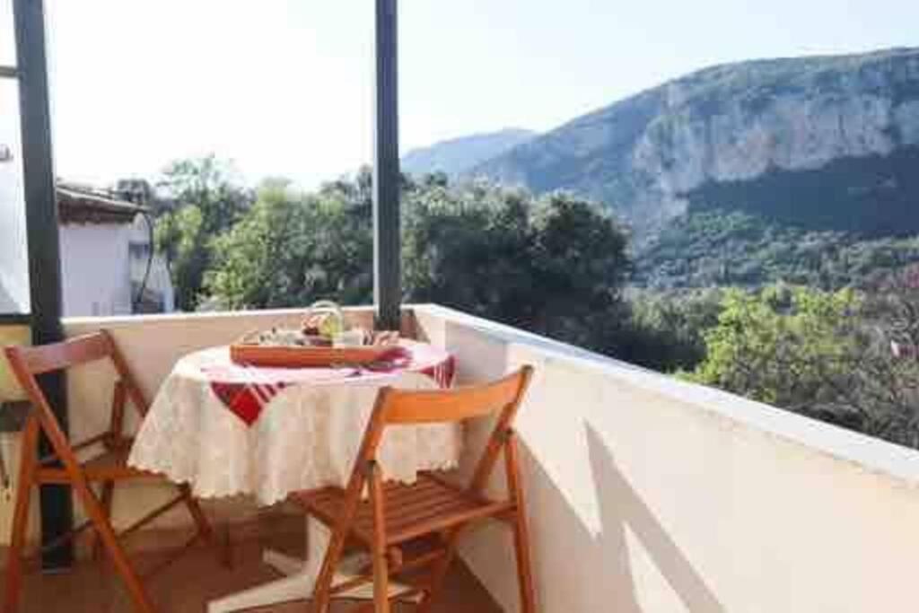 a table and chairs on a balcony with a view at “ Nicolas traditional house” in Gardeládes