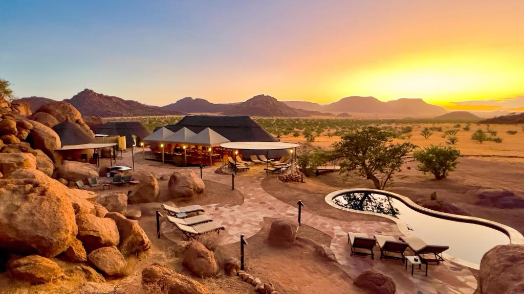 an aerial view of a resort in the desert at sunset at Twyfelfontein Adventure Camp in Khorixas