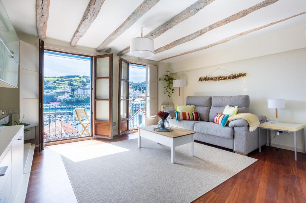 a living room with a couch and a table at IZARO Best View in Bermeo