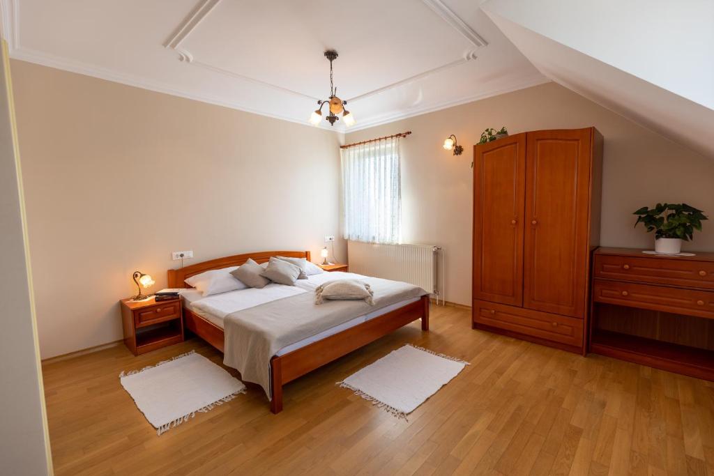 a large bedroom with a bed and a dresser at Tourist farm Tominc in Brezje