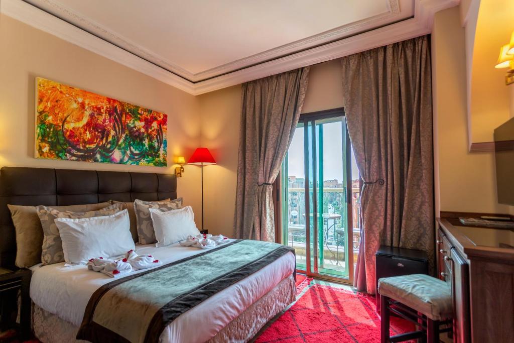 Postel nebo postele na pokoji v ubytování Le Caspien Boutique Hotel