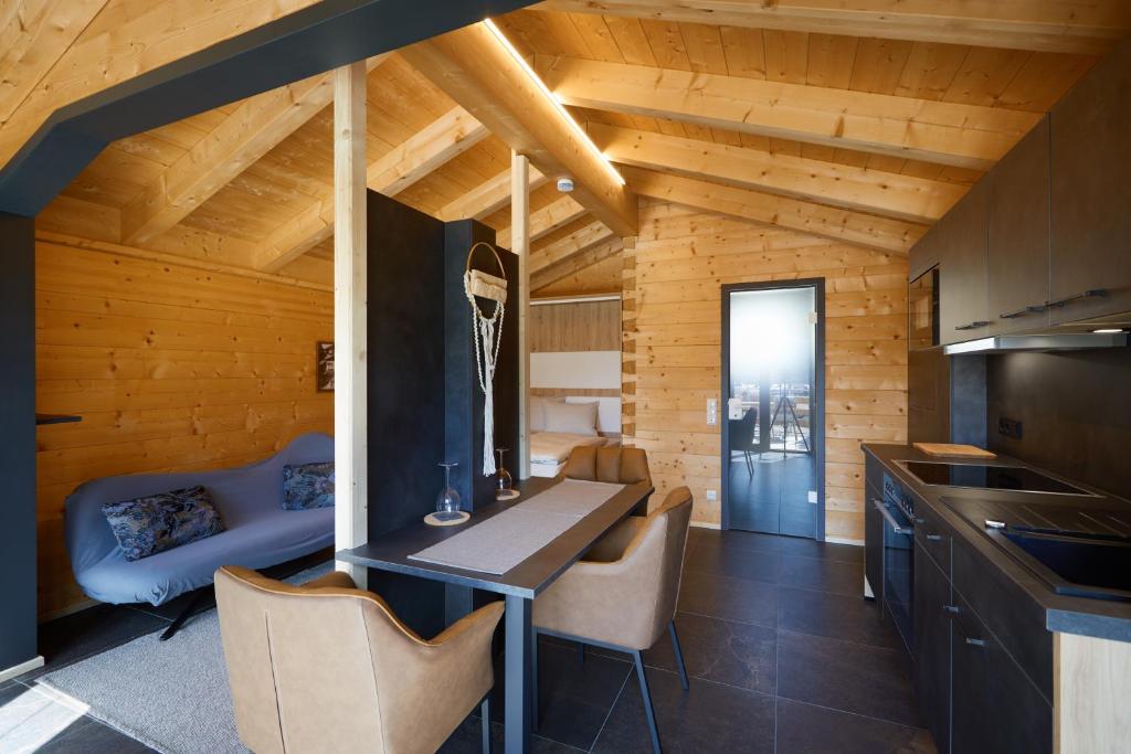 a kitchen and dining room with a table and chairs at Achners Chalet am Forsthaus in Wallgau