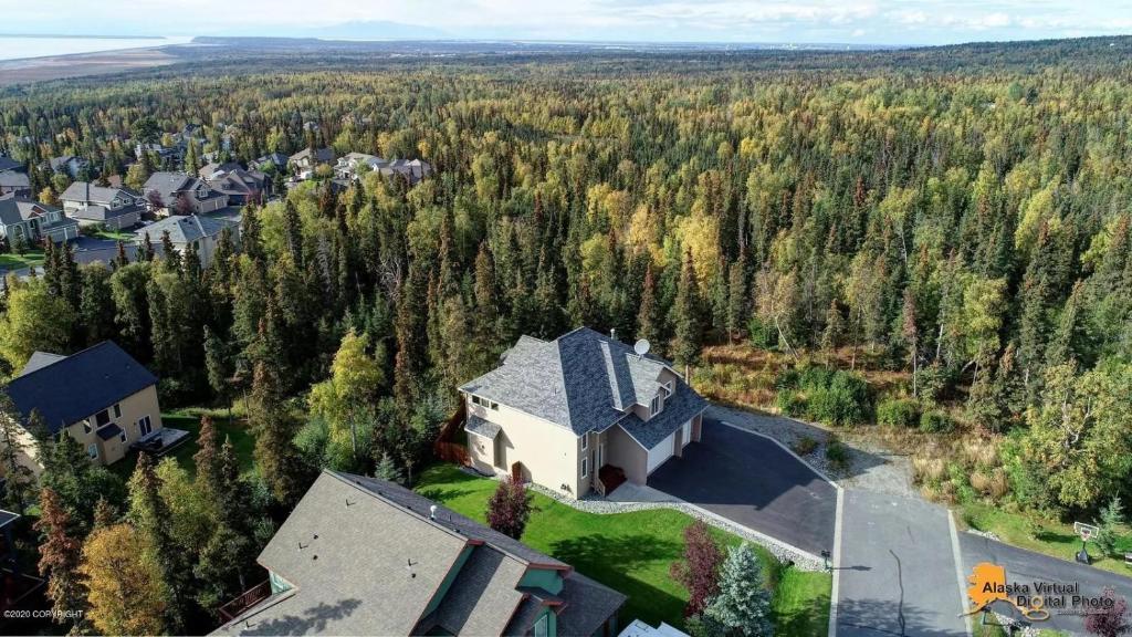 an aerial view of a house in the middle of a forest at Alaskan Sunset House - Ground Floor Unit in Anchorage